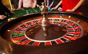 Mobile phone screen showing live blackjack table interface with dealer hand and player betting panel